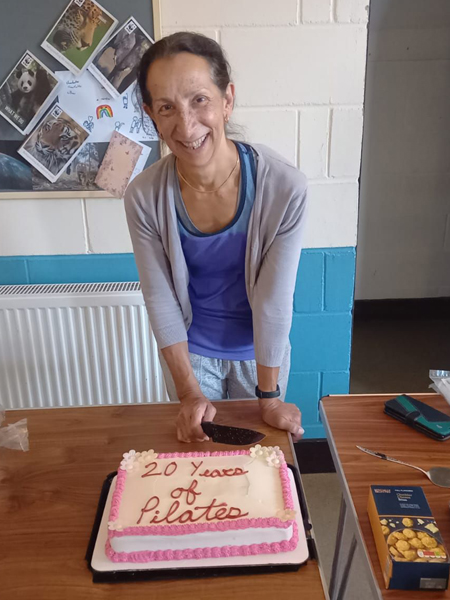 Rosemary cutting her 20 years of Pilates cake.
